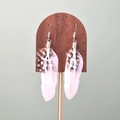 Bohemian feather earrings with white feathers and silver beads on a dark wood stand - White