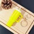 Mini yellow cup keychain for lip balm with gold clip on a wooden tray - Dazzling Yellow / Gold Buckle