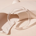 Artistic close-up of a minimalist clear acrylic round bangle on geometric blocks - Clear