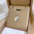 Detailed macro view of an oval rose relief pendant on a silver titanium steel necklace - Embossed Rose Oval Pendant Silver (N233)