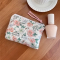 Close-up of floral cotton pouch with pink braided handle on a wooden tabletop - Pink Flower