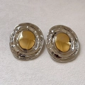 Detail of twisted circular earrings featuring silver lava texture and gold metal center - 30# Silver Earring Post - Silver/Gold Two-tone - Oval