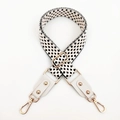 Macro detail of black and white jacquard strap with white leather and gold buckles - White