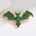 Golden bat brooch with sparkling green rhinestones and a large teardrop gemstone inlay - Green