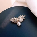 Macro detail of leaf-shaped brooch with marquise crystals and white pearl drop charm - Angel Wings Style (X0288)