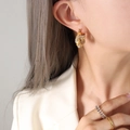 Elegant twisted U-shape gold-plated steel earrings with shimmering zircon pavé stones - Large / Gold With White Zircon