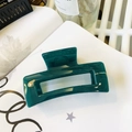 Detail of dark emerald green rectangular hair claw clip on lifestyle background - Malachite green