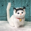 Detailed view of plush cat toy with white fur, red collar and golden bell ornament - White Cat With Black Head Sound