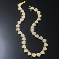 Luxury gold Cuban link necklace with iced out heart charms on black reflective background - 20 inch / Gold