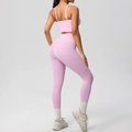 Detail of cross back yoga set featuring thin straps and high-waist peach leggings - Sakura Pink