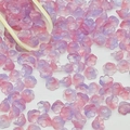 Macro shot of 7x12mm lily of the valley gradient beads with a small wooden scoop - Lily of the Valley 15# Pink Purple 7x12mm