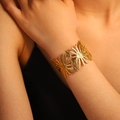 Elegant wide open gold cuff bracelet with intricate hollow leaf patterns for women - Abstract Star