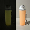 Luminous keychain pendant in orange showing green glow in the dark effect - Night Light Orange