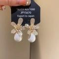 Close-up of sparkling floral earrings with teardrop pearls on a silver 925 jewelry tag - Gold-White Gold Plated (27# Silver Pin)