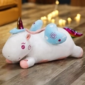White plush unicorn toy with rainbow tail and blue wings in a cozy lying pose - Regular Fit / 50cm / White