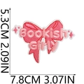 Pink bow embroidered patch with Bookish Girl text and detailed fabric stitch texture - US 9