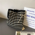 Detail of striped knit tote bag featuring a pleated texture and beige bow decoration - Black & Beige Stripes