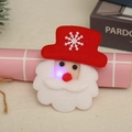 Close-up of felt Santa Claus brooch with LED light effect and snowflake detail - Glowing Santa Style
