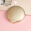 Portable folding round metal makeup mirror in polished gold finish with button - 70mm / Rose Gold