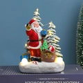 Statuetta di Babbo Natale luminosa con regali e alberi su base innevata - Babbo Natale