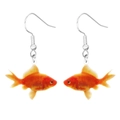 Macro shot of cute goldfish-shaped acrylic earrings with vibrant red and orange tones - Goldfish