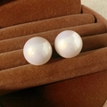Macro shot of high-quality round pearl earrings with mirror-like luster on velvet tray - Silver Needle - White - Medium
