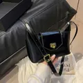 Classic black patent leather underarm bag with an elegant vintage golden square buckle - Black