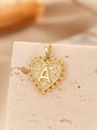 Macro detail of gold heart pendant with letter A engraving and hammered texture finish - Gold Heart Pattern Letter A
