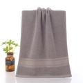 Thick dark gray cotton towel with triple gold stripe accents and soft terry texture - Jinli Brown