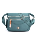 Waterproof nylon crossbody bag in turquoise with multiple zipped pockets and adjustable strap - Lake Blue