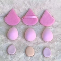 Macro shot of 9-piece pink makeup sponge set with puffs on white plush background - Pink 9-Piece Set