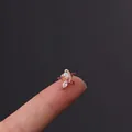 Star-shaped rose gold stud earring with opal and marquise zircon on a fingertip - Iridescent Star Style (3#R)