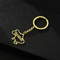 Detail of a golden Ukraine map keychain with Ukraina engraving on black background - Map with Cyrillic Text / Gold