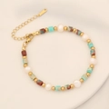 Detail of beaded bracelet with natural stones, white pearls, and gold extension chain - Green Imperial Jasper