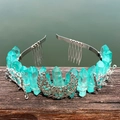 Detail of turquoise crystal crown with silver moon and branch accents on a metal headband - Green