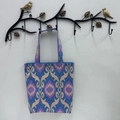 Detail of blue purple ikat pattern tote bag hanging on a decorative metal bird wall hook - Sapphire Blue