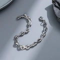 Detailed view of silver stainless steel curb chain bracelet with lobster clasp on rock - gf83-Figure 8 Infinity Symbol