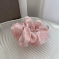 Macro detail of pink satin scrunchie featuring decorative silver rhinestones on texture - Pink