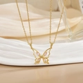 Elegant gold butterfly necklace with pink marquise zircon stones and hollow design - Gold Hollow Pink Stone Butterfly Necklace XL0451