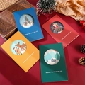 Set of four circular cutout Christmas cards with festive scenes and envelopes on red fabric - Hollow Illustration Style (s424)