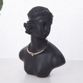 Élégant collier doré avec accents de cristal exposé sur un buste de mannequin noir - 21x17cm / Noir