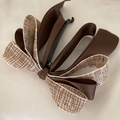 Detail of tweed and satin ribbon bow hair clip with a black plastic banana clip base - Coffee Tweed Bow
