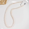 Detailed view of freshwater rice pearls with silver lobster clasp and heart charm tag - 5-6mm Basic Pearl Chain
