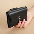 Quilted black short wallet featuring golden flower buckle and secure zipper closure - Black