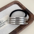 Minimalist silver multi-layer metallic hair tie with black elastic band on a wooden tray - #9 Silver Four-bar