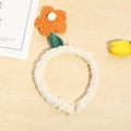 Detailed view of a soft plush tulip headband with orange petals and green velvet leaves - Orange Flower