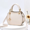 Elegant cream white semi-circular handbag with gold zipper trim and leaf charm detail - Off White
