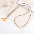Detail of luxury rhinestone crossbody phone chain in gold and silver with yellow clip - White + Champagne
