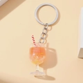 Detailed view of a mini glow cocktail cup keychain with fake ice and a striped straw - Red