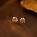 Elegant pair of S999 silver stud earrings featuring amber orange round-cut stones - November Champagne